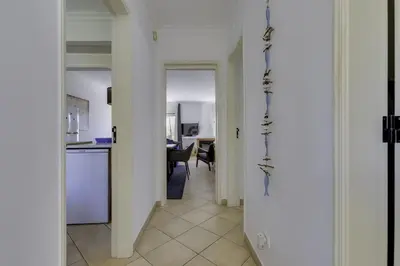 a hallway with a kitchen and a dining room at CLUB ALBUFEIRA - 2 bedroom apartment, air conditioning and pools in Albufeira