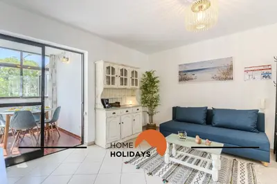 a living room with a blue couch and a table at #321 Lageado 1S by Home Holidays in Vale de Pedras