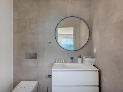 a bathroom with a white sink and a mirror at Holiday Home Nannoush - Vip Properties by Interhome in Albufeira