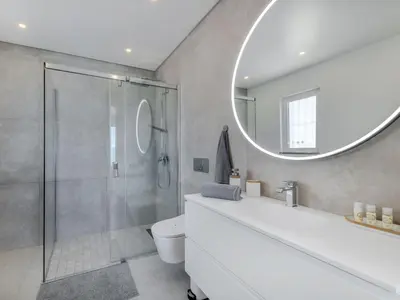 a bathroom with a shower and a sink and a mirror at Holiday Home Nannoush - Vip Properties by Interhome in Albufeira