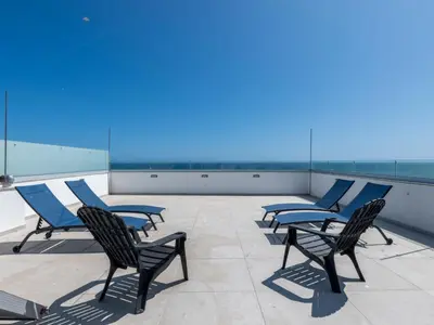 a row of chairs on the roof of a building at Holiday Home Nannoush - Vip Properties by Interhome in Albufeira