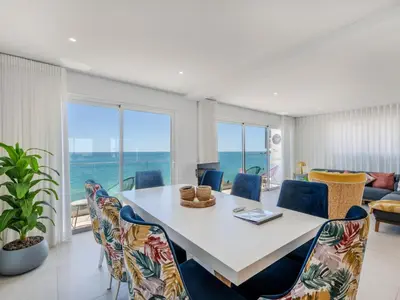 a dining room with a table and chairs with a view of the ocean at Holiday Home Nannoush - Vip Properties by Interhome in Albufeira