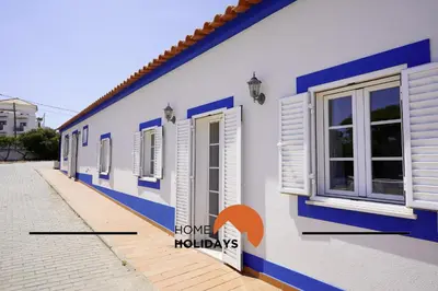 a bedroom with a bed with a home holidays sign on it at #331 Casa Chico Rita by Home Holidays in Sesmarias