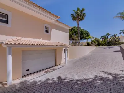 a driveway in front of a house with a garage at 1 bdr apartment with pool next to Laguna Golf Course in Vilamoura