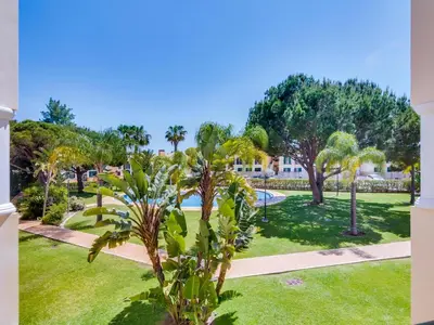 a view of a park with palm trees at 1 bdr apartment with pool next to Laguna Golf Course in Vilamoura