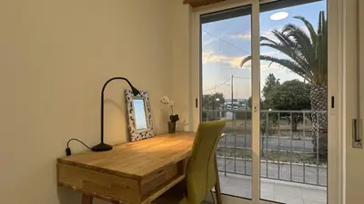 a dining room table with a mirror and a window at Figo by Check-in Portugal in Quarteira