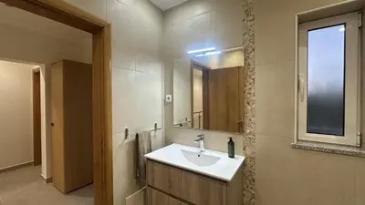 a bathroom with a sink and a mirror at Figo by Check-in Portugal in Quarteira