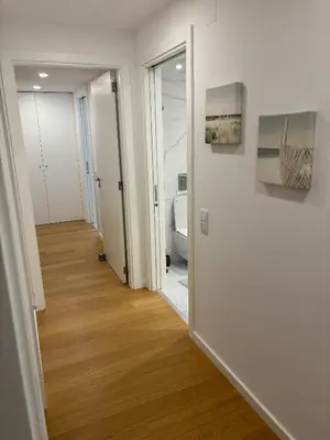 a hallway with a door leading to a bathroom at Casa Verde in Albufeira