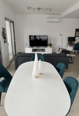 a living room with a white table and blue chairs at Casa Verde in Albufeira