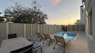 a patio with chairs and a swimming pool at Amêndoa by Check-in Portugal in Quarteira