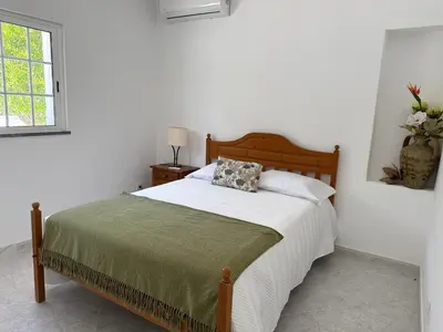 a bedroom with a bed with a pillow on it at Solar dos Lirios in Loulé