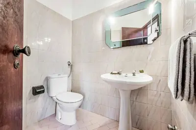 a bathroom with a toilet and a sink and a mirror at Villa Julia Gale in Guia