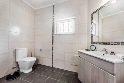a bathroom with a toilet and a sink and a mirror at Villa Julia Gale in Guia