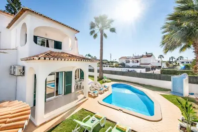 a villa with a swimming pool and a house at Villa Julia Gale in Guia