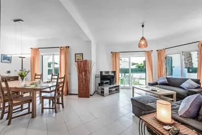 a living room with a couch and a table at Villa Julia Gale in Guia