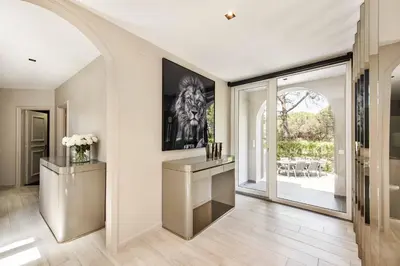 a living room with a table and a large window at Villa Melvin in Quarteira