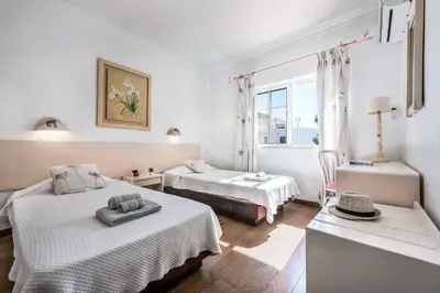 a bedroom with two beds and a window at Villa Casanova Golf in Quarteira