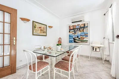 a dining room with a glass table and chairs at Villa Casanova Golf in Quarteira