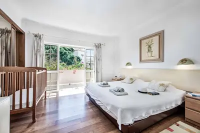 a bedroom with a bed and a crib in it at Villa Casanova Golf in Quarteira