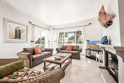 a living room with two couches and a fireplace at Villa Casanova Golf in Quarteira