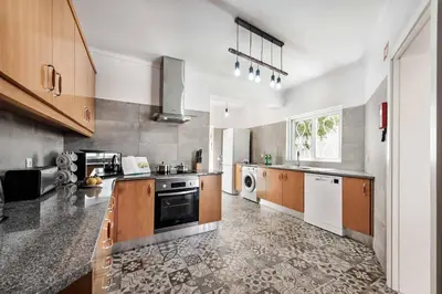 a large kitchen with a stove and a dishwasher at Villa Barbara in Albufeira