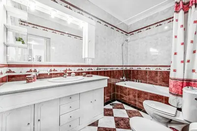 a bathroom with a sink and a tub and a toilet at Villa Mogan in Albufeira