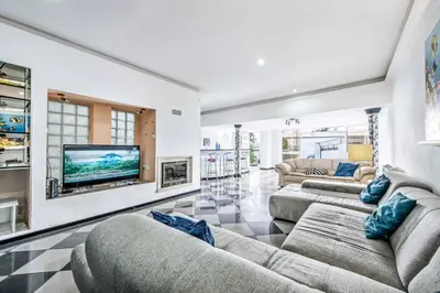 a living room with two couches and a flat screen tv at Villa Mogan in Albufeira