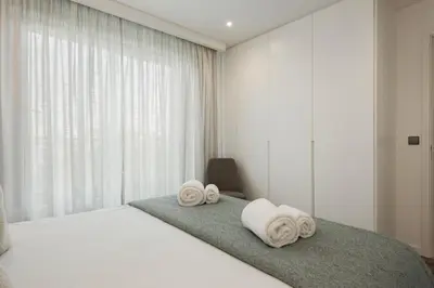 a bedroom with a bed with towels on it at Terracos de Quarteira II Caribe by Real Properties in Quarteira