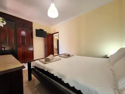 a bedroom with a bed with two phones on it at Sun House in Albufeira