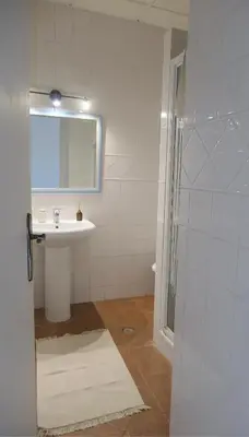a bathroom with a sink and a shower with a mirror at Manso da Falésia in Olhos de Água