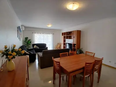 a living room with a table and a couch at Albufeira Baixa Apartment in Albufeira
