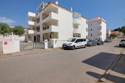 a white van parked in front of a building at Excellent Apartment in Olhos D´Água in Olhos de Água