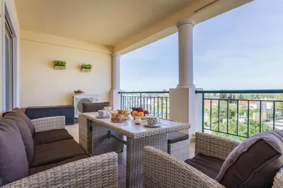 a porch with chairs and a table with fruit on it at Bright 3-BR in Guia with Shared Pool by Lisbeyond in Guia