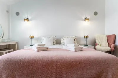 a bedroom with a large bed with towels on it at Bright 3-BR in Guia with Shared Pool by Lisbeyond in Guia