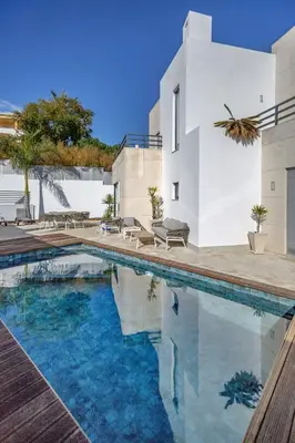 a swimming pool in front of a house at Villa Velluto in Albufeira