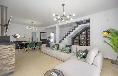 a living room with a couch and a dining room at Villa Velluto in Albufeira