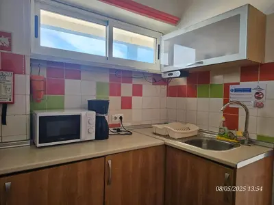 a kitchen with a sink and a microwave at Blife Vistaya private rooms at Faro beach in Faro
