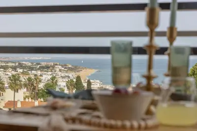 a table with a view of a beach and the ocean at Ocean glimpse in Albufeira