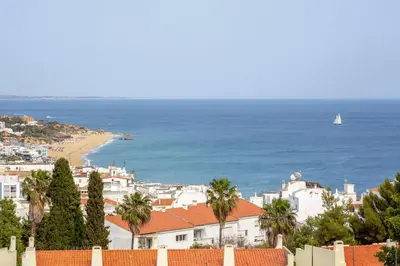 a view of a beach with a boat in the water at Ocean glimpse in Albufeira