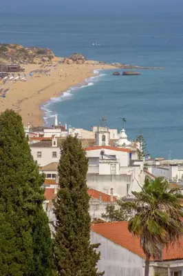 a city with a beach and buildings and trees at Ocean glimpse in Albufeira