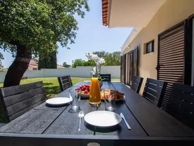 a wooden table with a bowl of food on it at Vila Paço no Vale by Stay ici Algarve Holiday Rental in Albufeira
