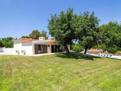 a house with a large lawn in front of it at Vila Paço no Vale by Stay ici Algarve Holiday Rental in Albufeira