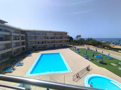 a large swimming pool in front of a building at Barracuda dom in Albufeira