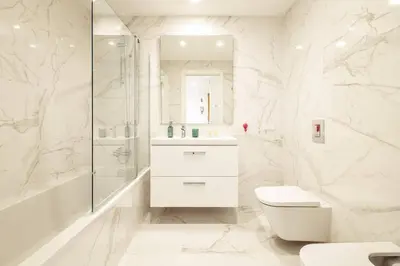 a white bathroom with a toilet and a shower at Modern 1-Bed Apartment with Terrace Albufeira in Albufeira