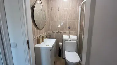 a bathroom with a toilet and a sink and a mirror at Blue Wave Albufeira in Albufeira