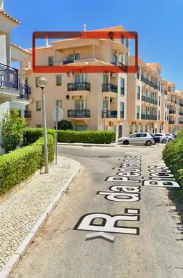a street in front of a building with a hotel at Blue Wave Albufeira in Albufeira