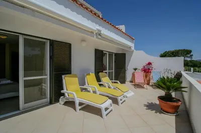 a group of chairs sitting on a patio at FLH Quinta do Lago Retreat with Terrace & Pool in Almancil
