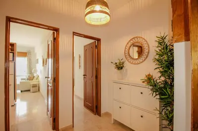 a hallway with a dresser and a mirror at FLH Quarteira Seaview in Quarteira