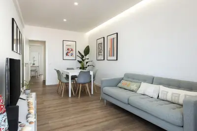 a living room with a couch and a table at Garret - Faro Apartment by HD in Faro