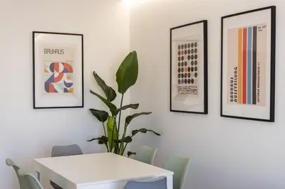 a dining room with a white table and chairs at Garret - Faro Apartment by HD in Faro